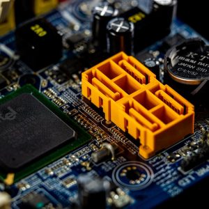 Detailed view of a computer motherboard showcasing an Intel microprocessor and electronic components.